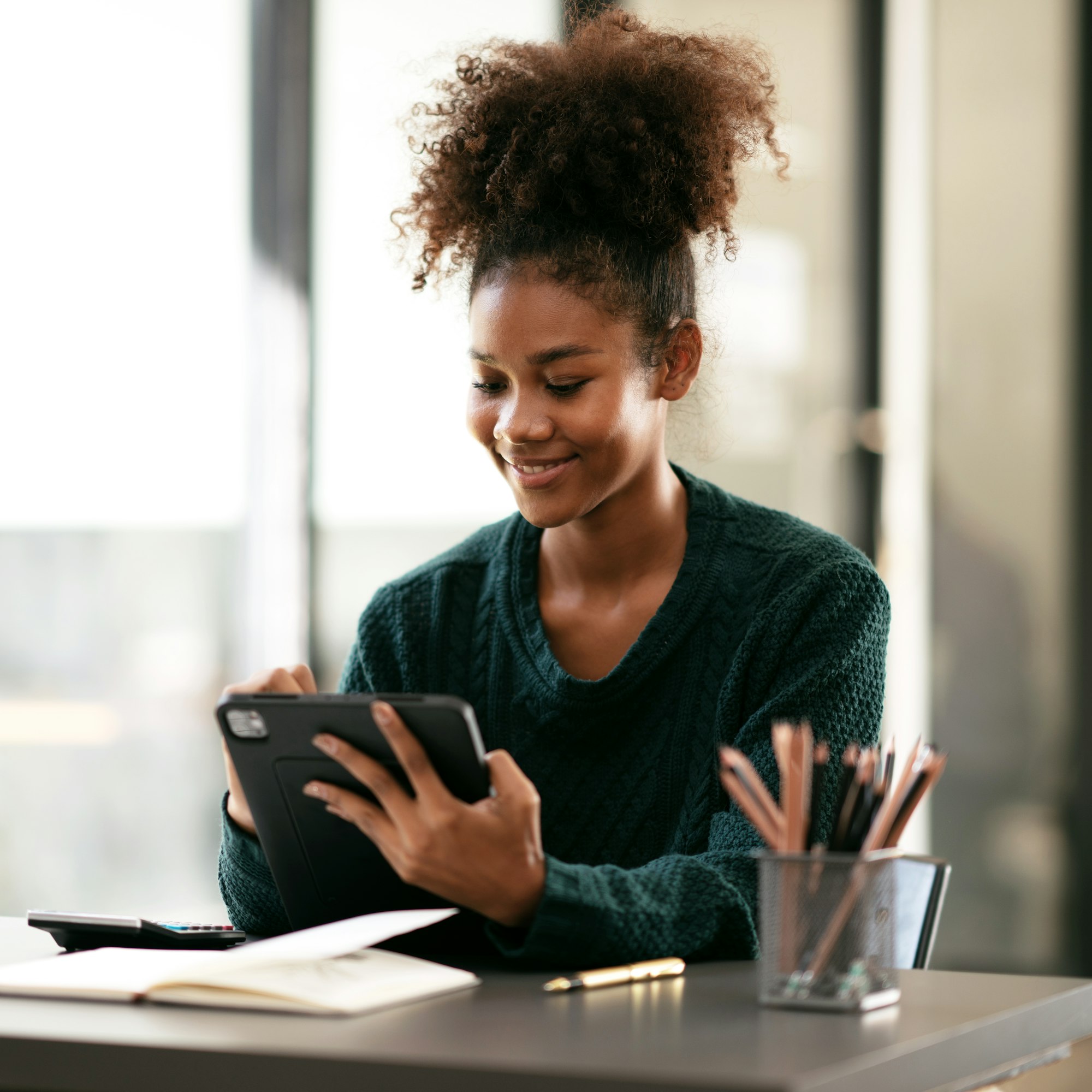 african american student woman in sweater writing information an