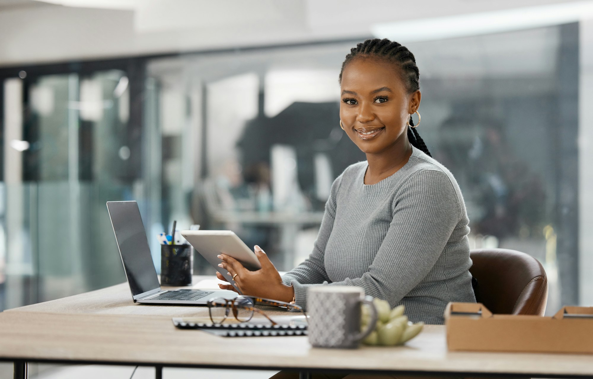 Welcome to my office. Shot of a confident young businesswoman holding her digital tablet.